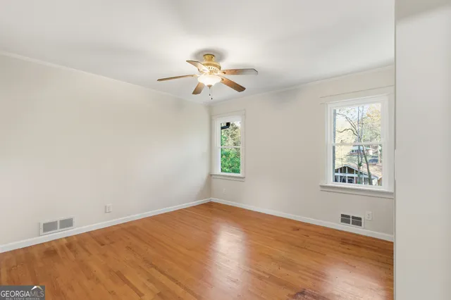 wooden floor in an empty room with a window