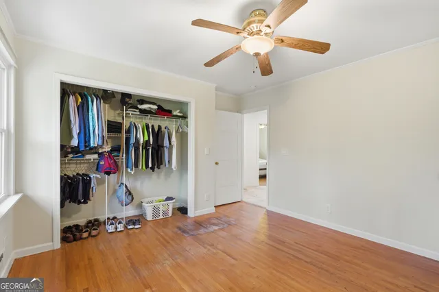 a view of a livingroom with wooden floor and a ceiling fan