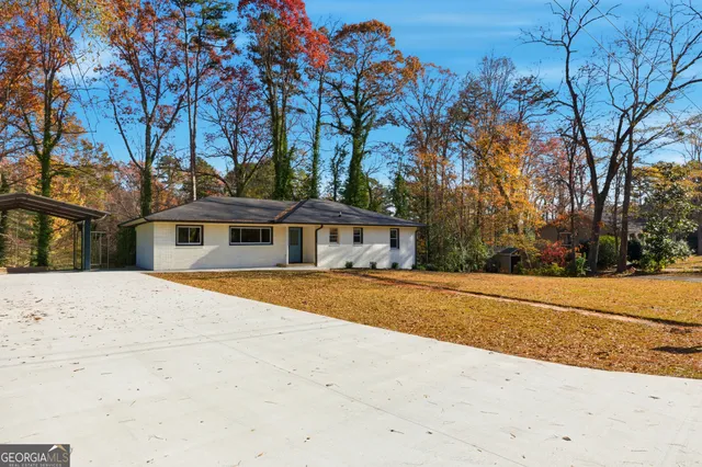 a backyard of a house with table and chairs