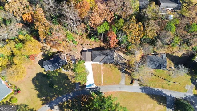 an aerial view of a house with a yard