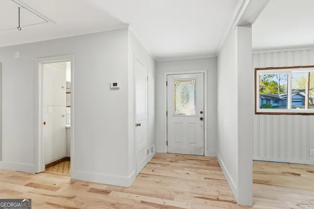a view of an empty room with wooden floor