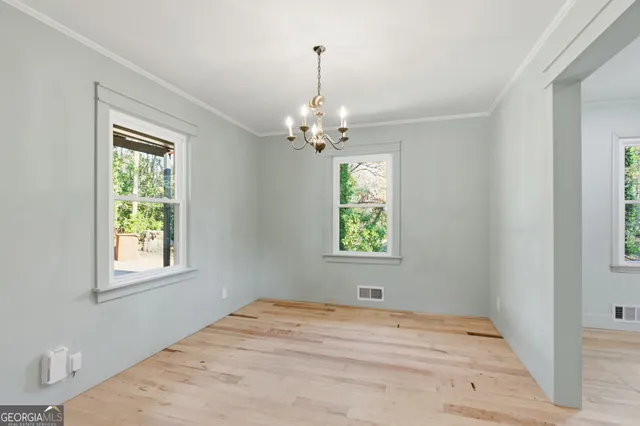 a view of a room with wooden floor and a window