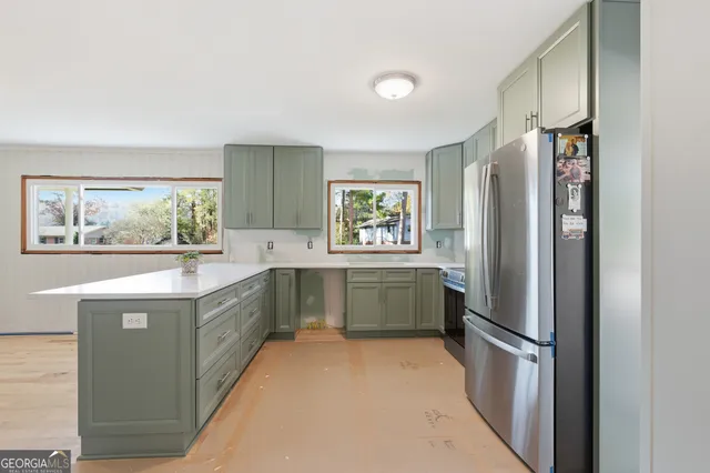 a kitchen with stainless steel appliances a refrigerator and a stove