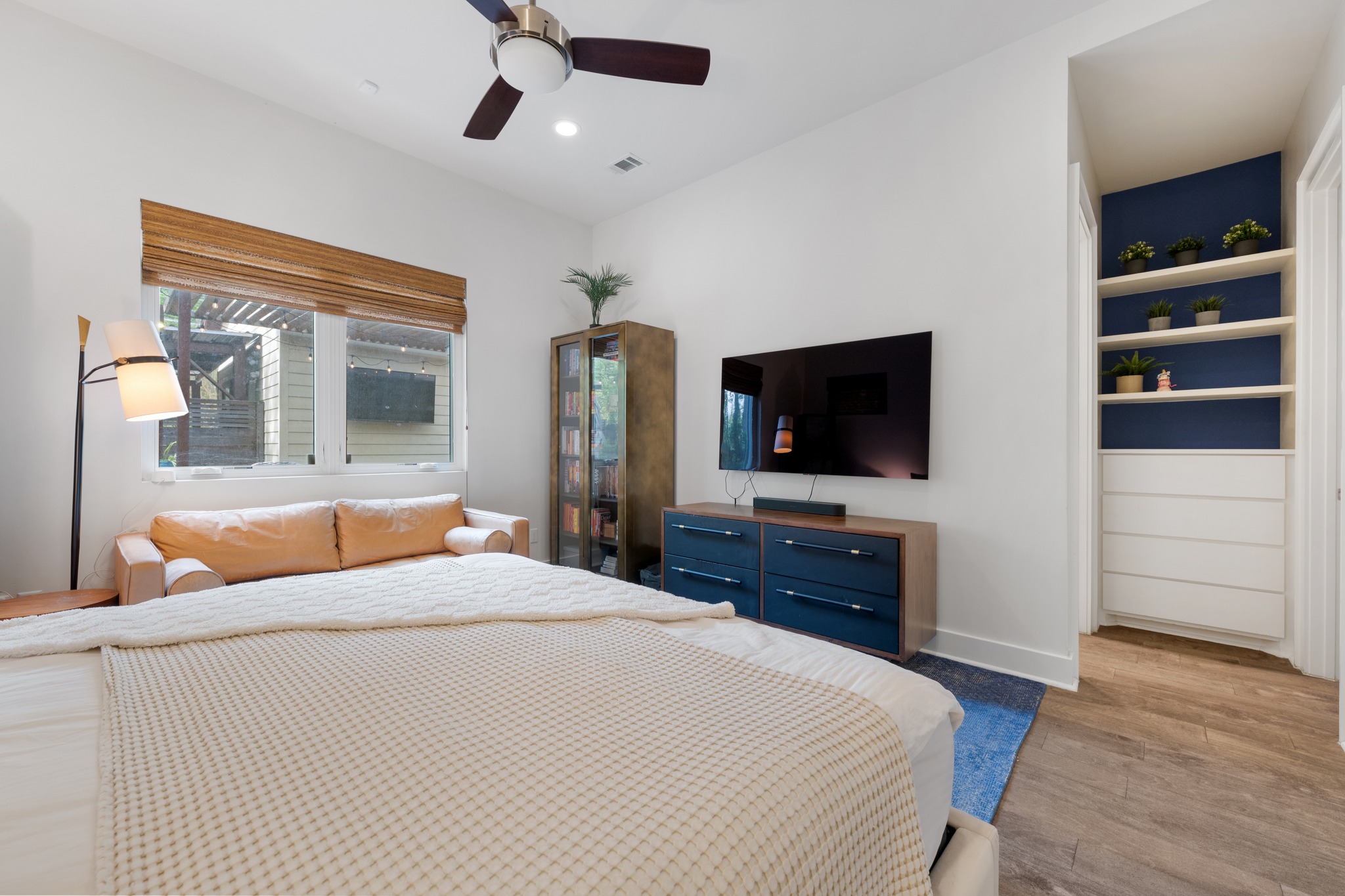 4904 Duval Street, Unit A Austin, TX 78751 - Photo 17 of 39 a bedroom with a bed and a flat tv screen on dresser