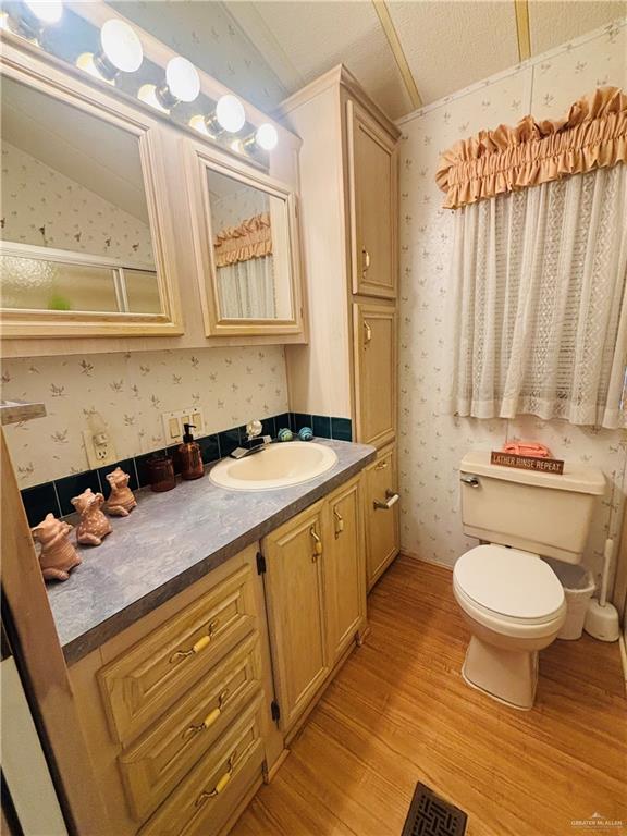 412 Sun Dial Circle Port Isabel, TX 78578 - Photo 19 of 37 a bathroom with a granite countertop sink toilet and a mirror
