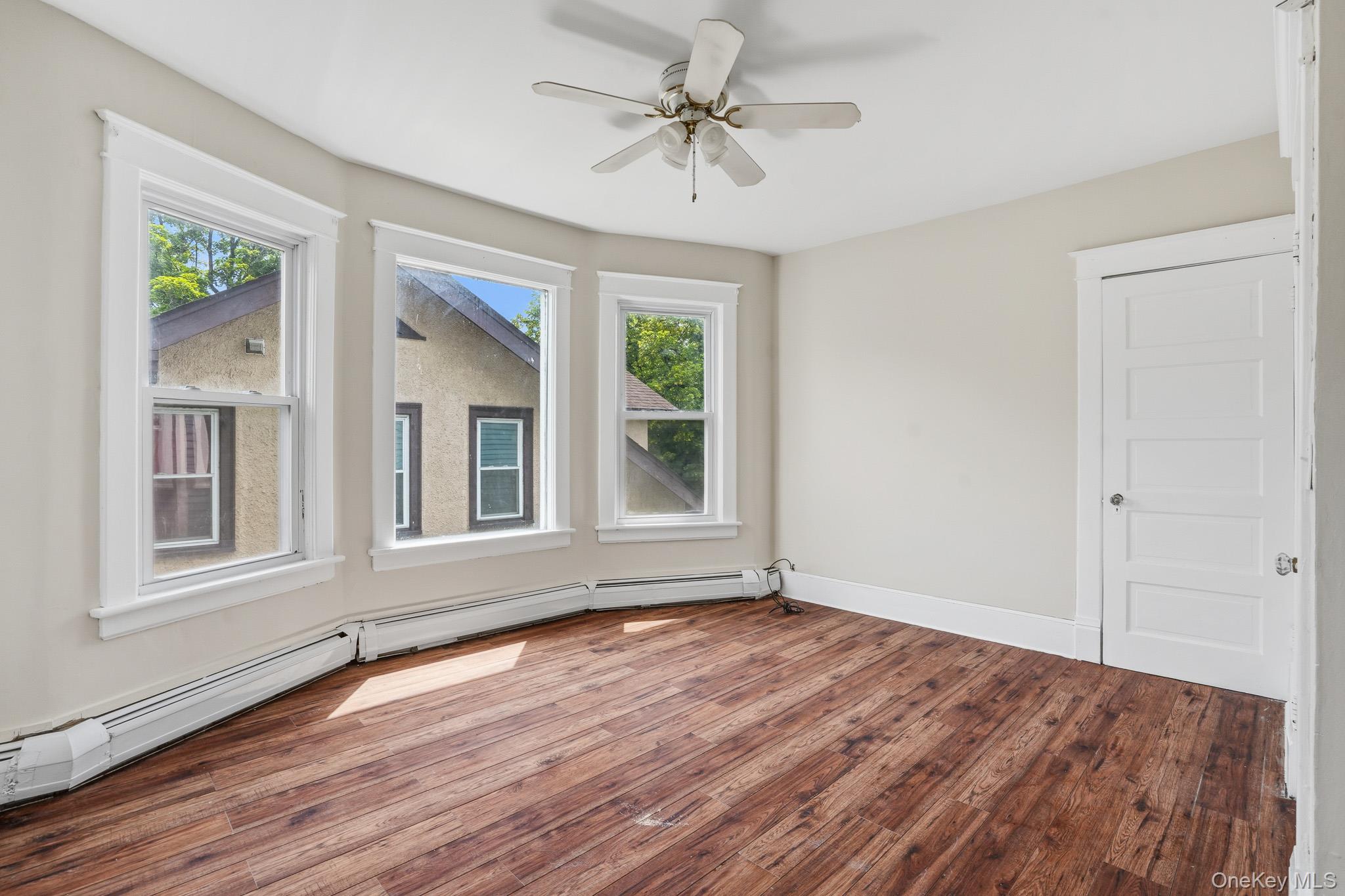 65 North Clinton Street Poughkeepsie, NY 12601 - Photo 31 of 43 a view of an empty room with wooden floor and a window