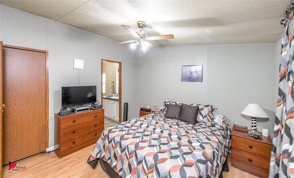 891 Pilgrim Rest Road Doyline, LA 71023 - Photo 23 of 37 a bedroom with a bed and a flat tv screen on dresser