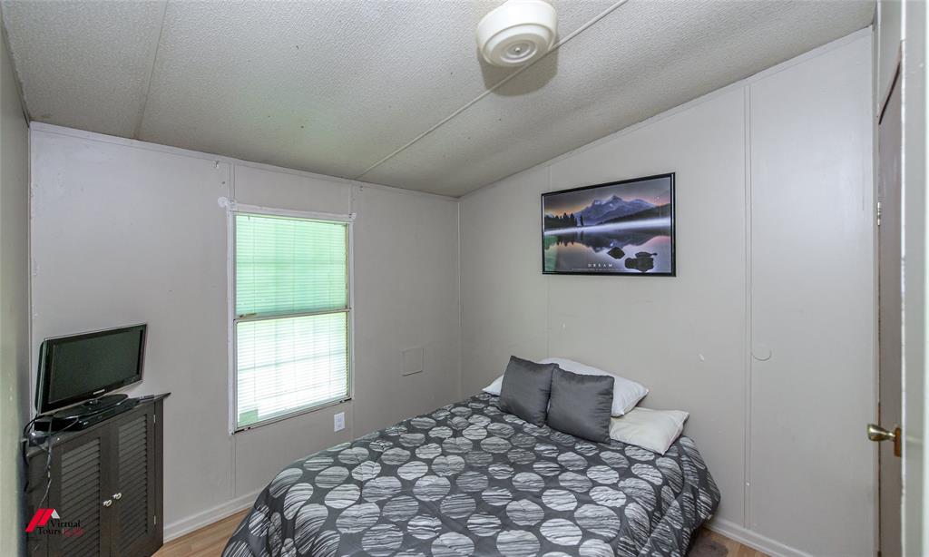 891 Pilgrim Rest Road Doyline, LA 71023 - Photo 26 of 37 a bedroom with a bed and a flat screen tv