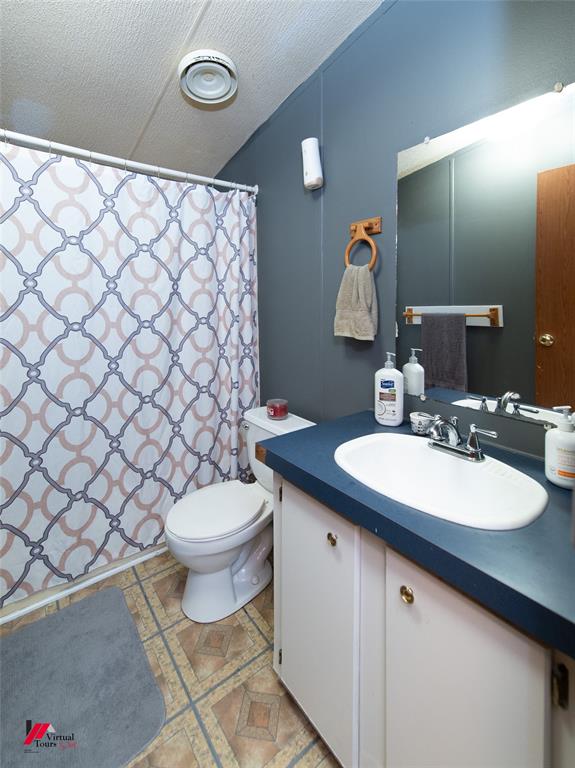 891 Pilgrim Rest Road Doyline, LA 71023 - Photo 29 of 37 a bathroom with a sink a toilet and mirror