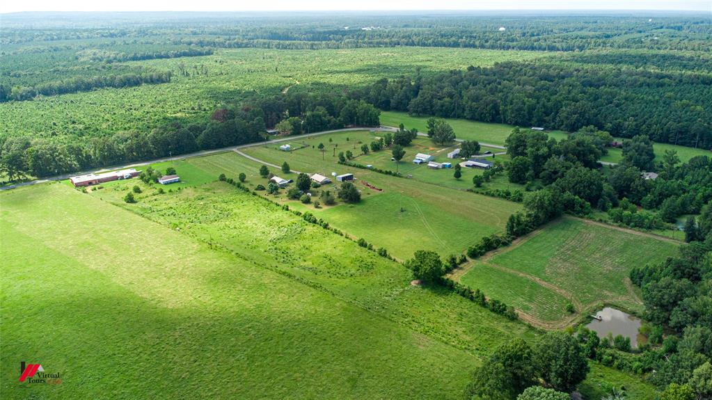 891 Pilgrim Rest Road Doyline, LA 71023 - Photo 34 of 37 an aerial view of green landscape with trees houses and mountain view