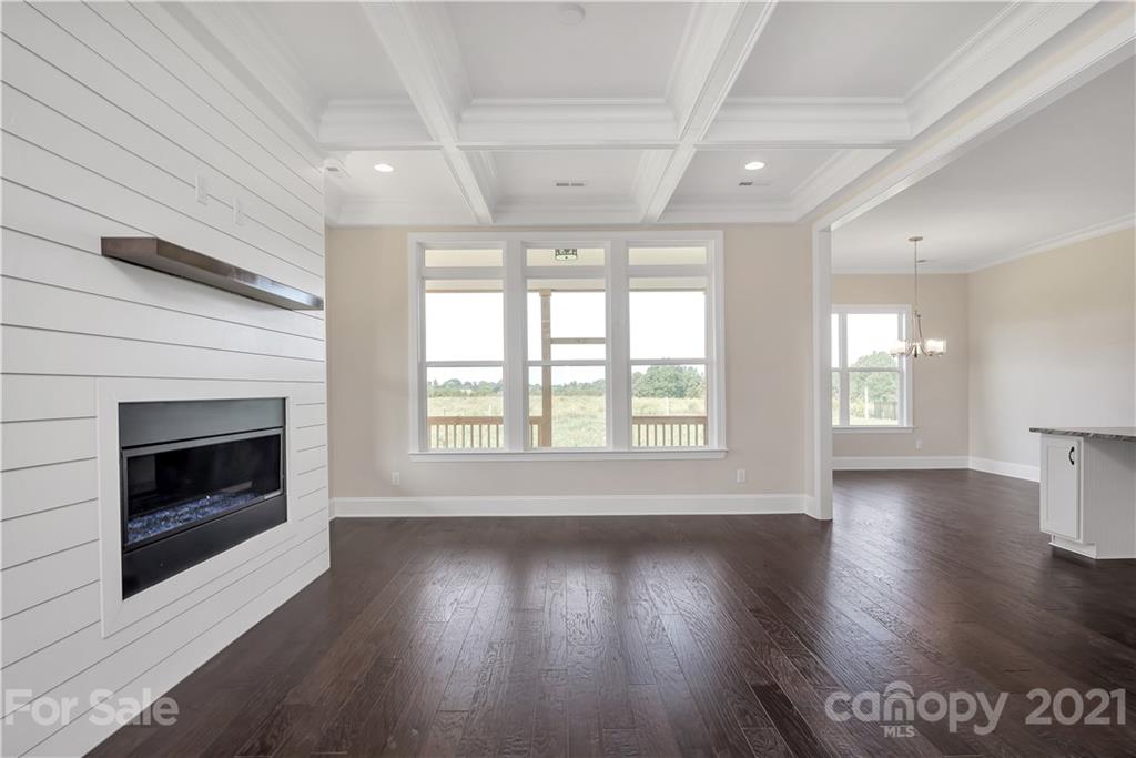 318 Grassy Rdg Court Clover, SC 29710 - Photo 13 of 31 a view of an empty room with wooden floor fireplace and a window