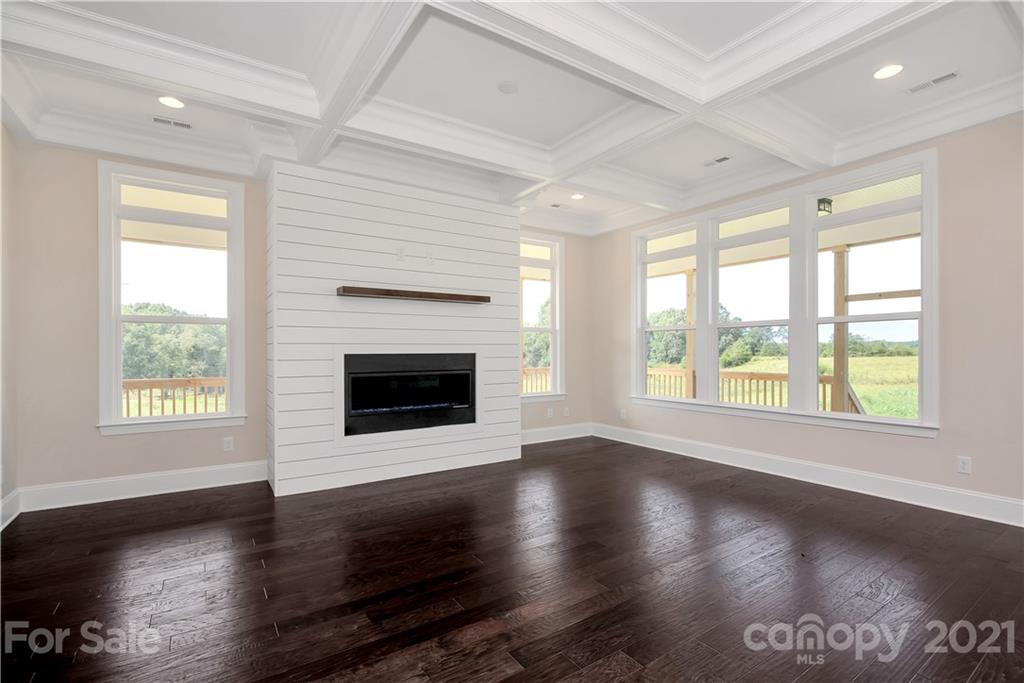 318 Grassy Rdg Court Clover, SC 29710 - Photo 14 of 31 an empty room with wooden floor and a fireplace