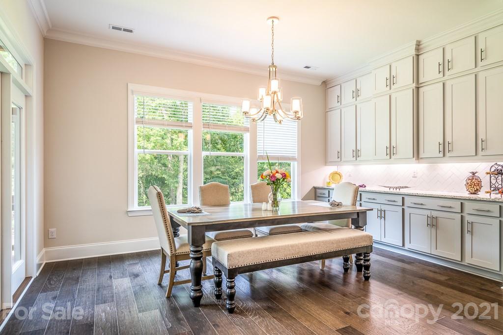 318 Grassy Rdg Court Clover, SC 29710 - Photo 10 of 31 a dining room with furniture a chandelier and wooden floor