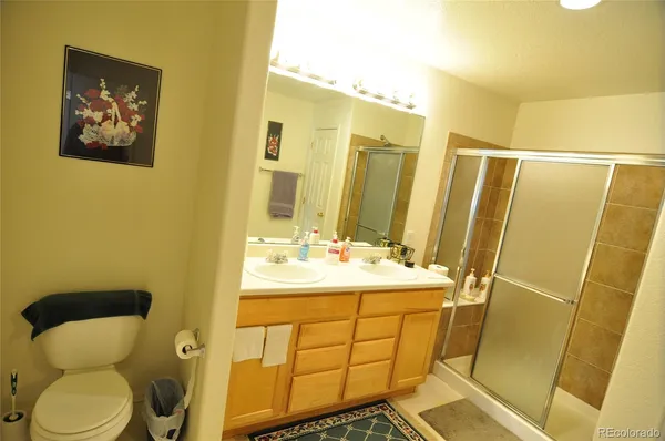 a bathroom with a sink and mirror with toilet