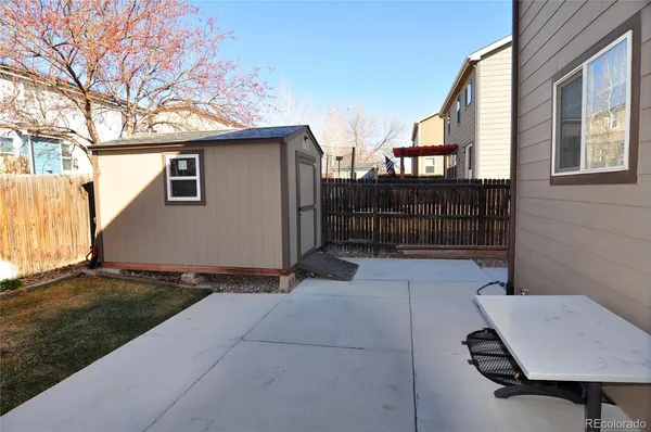 a view of backyard of house and car parked