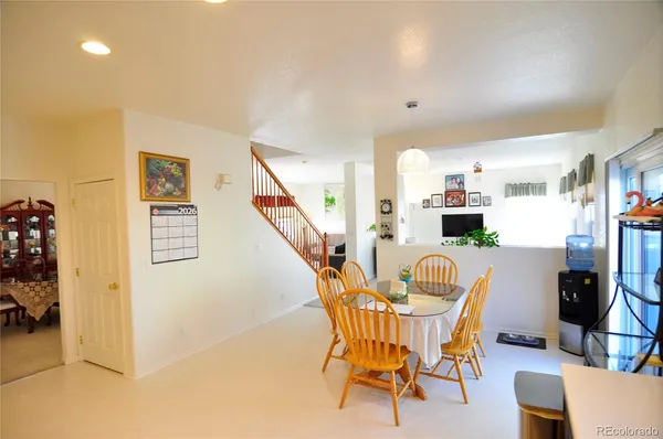 a dining room with furniture and wooden floor