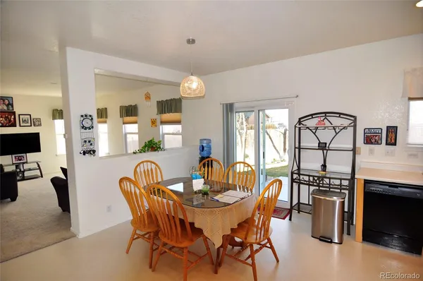 a view of a dining room with furniture and a chandelier