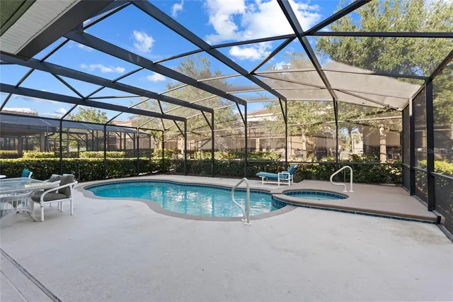 a view of an empty room and chandelier fan