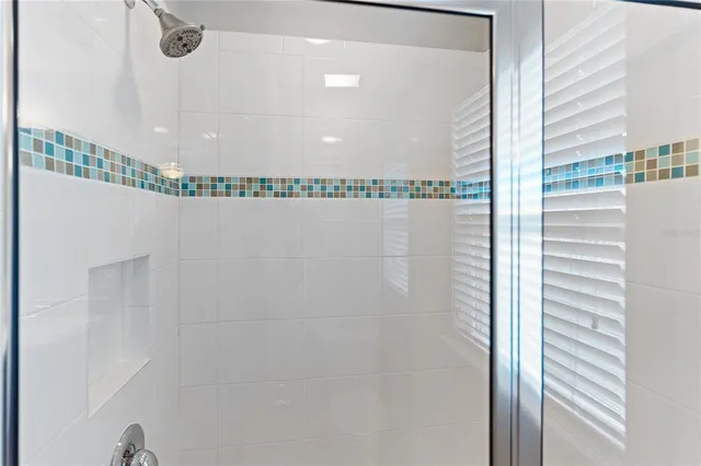 a bathroom with a granite countertop sink and a bathtub