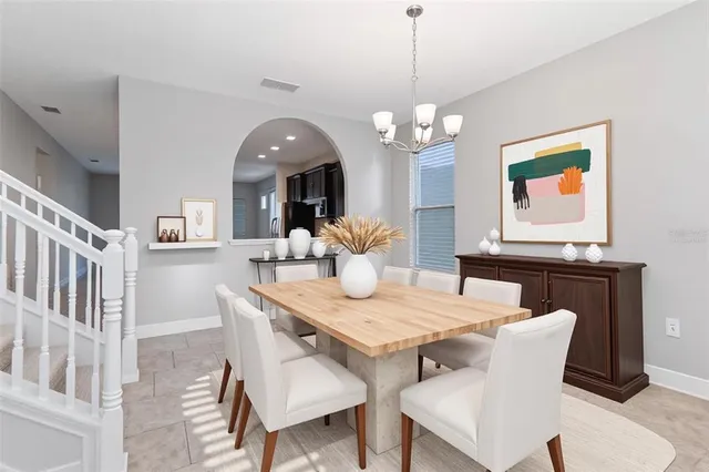 a view of a dining room with furniture wooden floor and chandelier