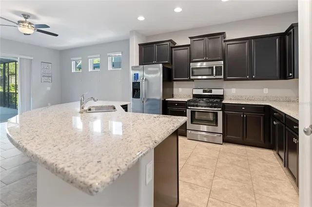 a kitchen with stainless steel appliances and granite countertop