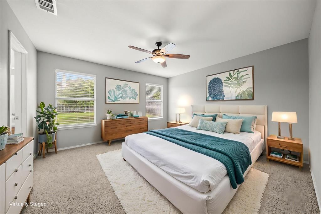 834 Hazel's Way Anna, TX 75409 - Photo 12 of 21 Spacious bedroom featuring light gray wall paint, neutral carpeting, multiple windows with blinds, and a ceiling fan with light fixture