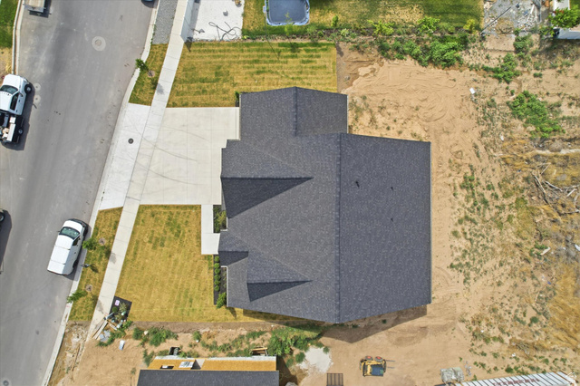 134 South Chamberlain Street Mapleton, UT 84664 - Photo 36 of 40 New construction residence with dark shingle roofing, concrete driveway, and a partially landscaped front yard