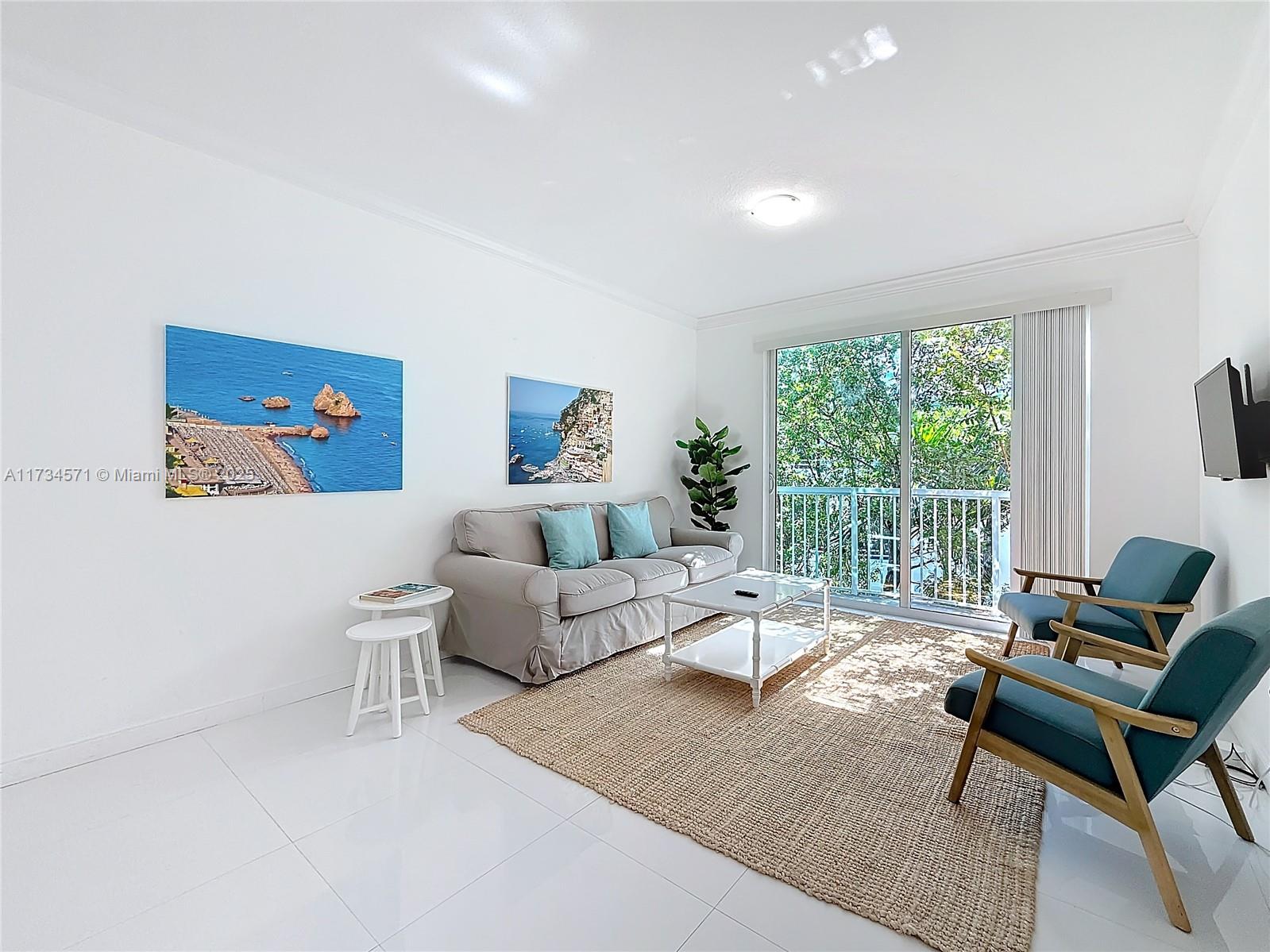 9172 Collins Avenue, Unit 414 Surfside, FL 33154 - Photo 15 of 23 a living room with furniture and a large window