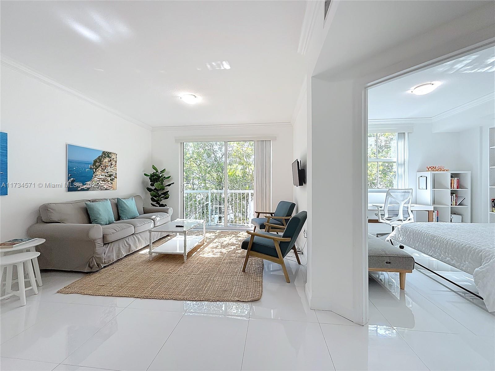 9172 Collins Avenue, Unit 414 Surfside, FL 33154 - Photo 17 of 23 a living room with furniture and a large window