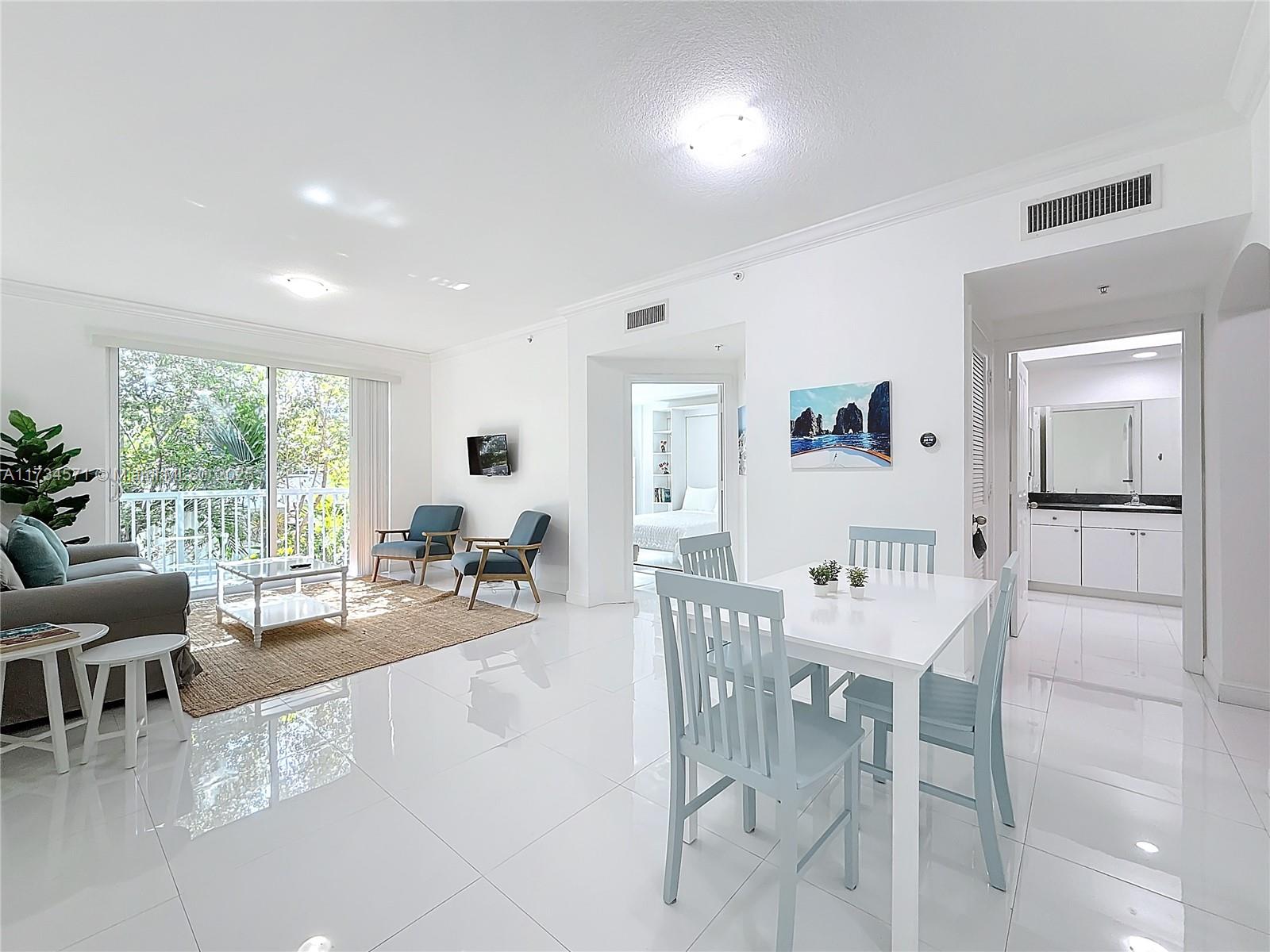9172 Collins Avenue, Unit 414 Surfside, FL 33154 - Photo 20 of 23 a view of a dining room with furniture and wooden floor