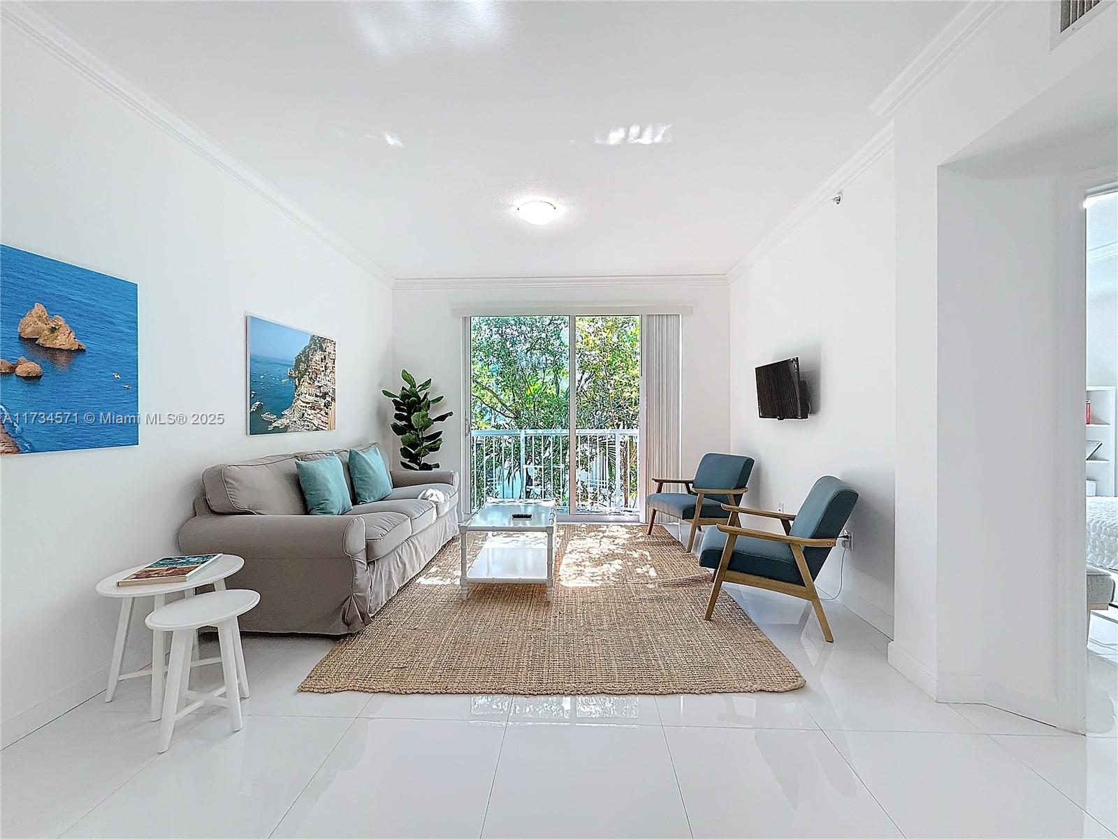 9172 Collins Avenue, Unit 414 Surfside, FL 33154 - Photo 3 of 23 a living room with furniture and large window