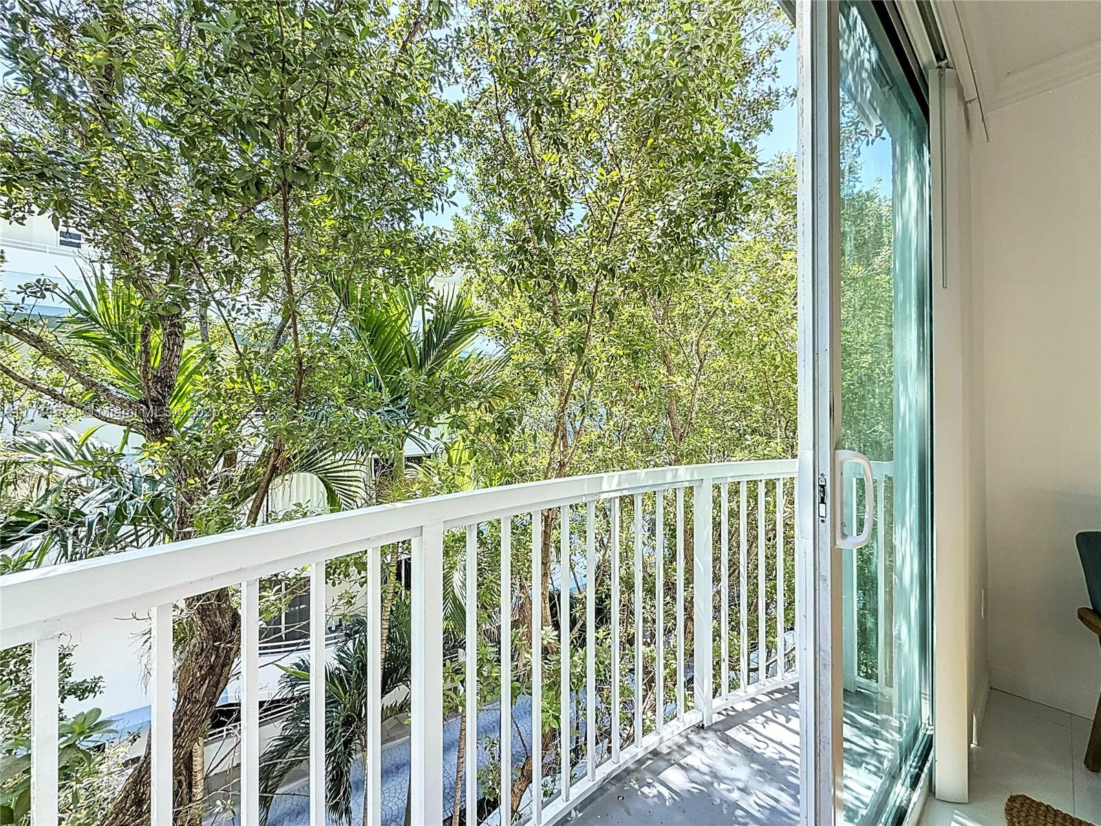 9172 Collins Avenue, Unit 414 Surfside, FL 33154 - Photo 8 of 23 a view of a balcony with wooden floor