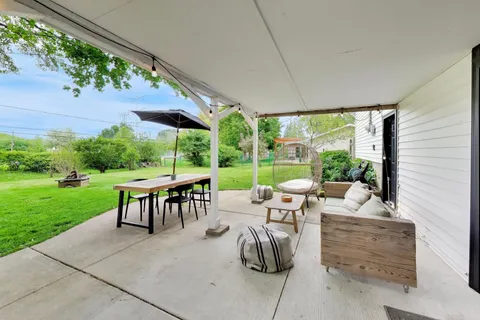 a view of a patio with chairs and plants