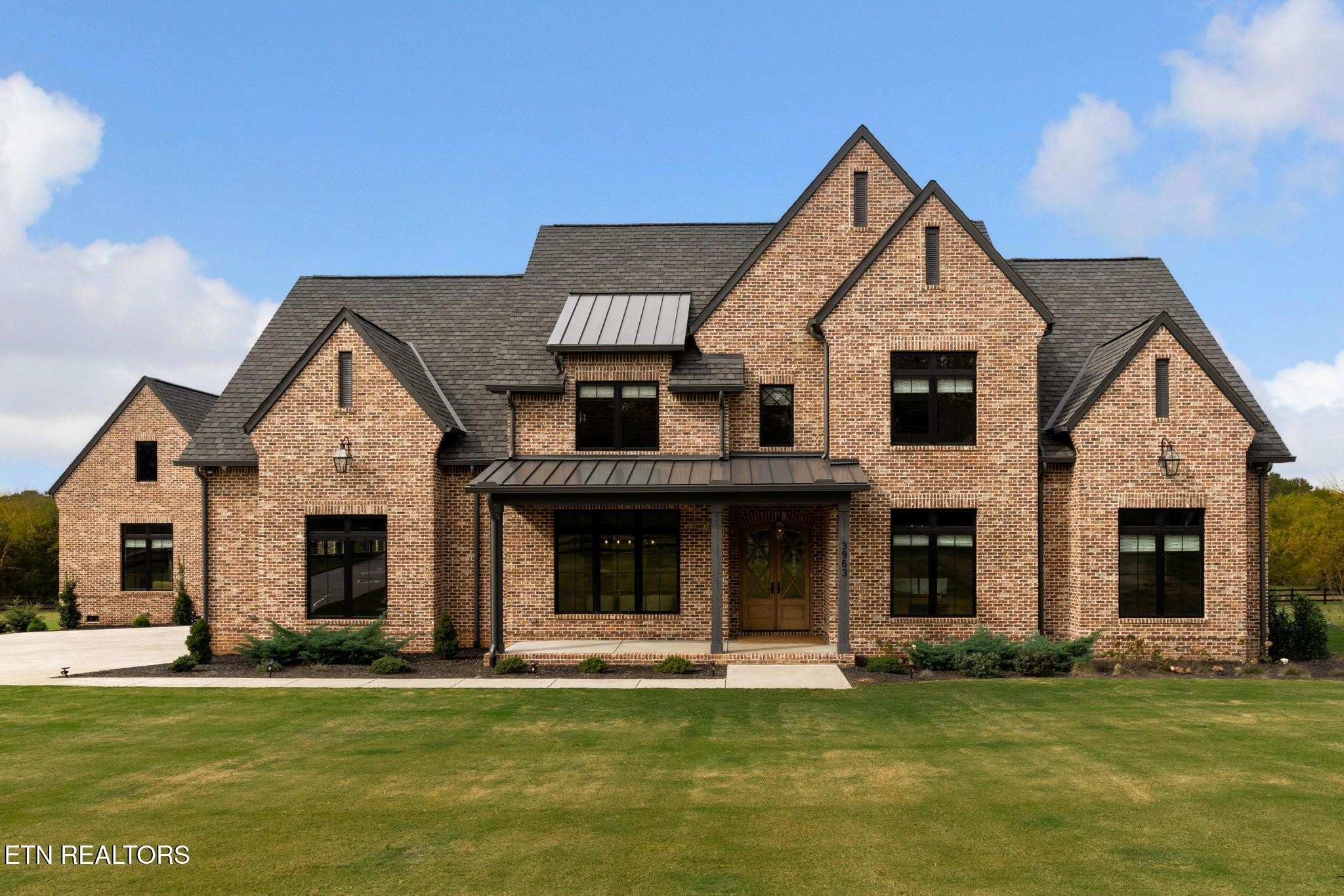 a front view of a house with a yard