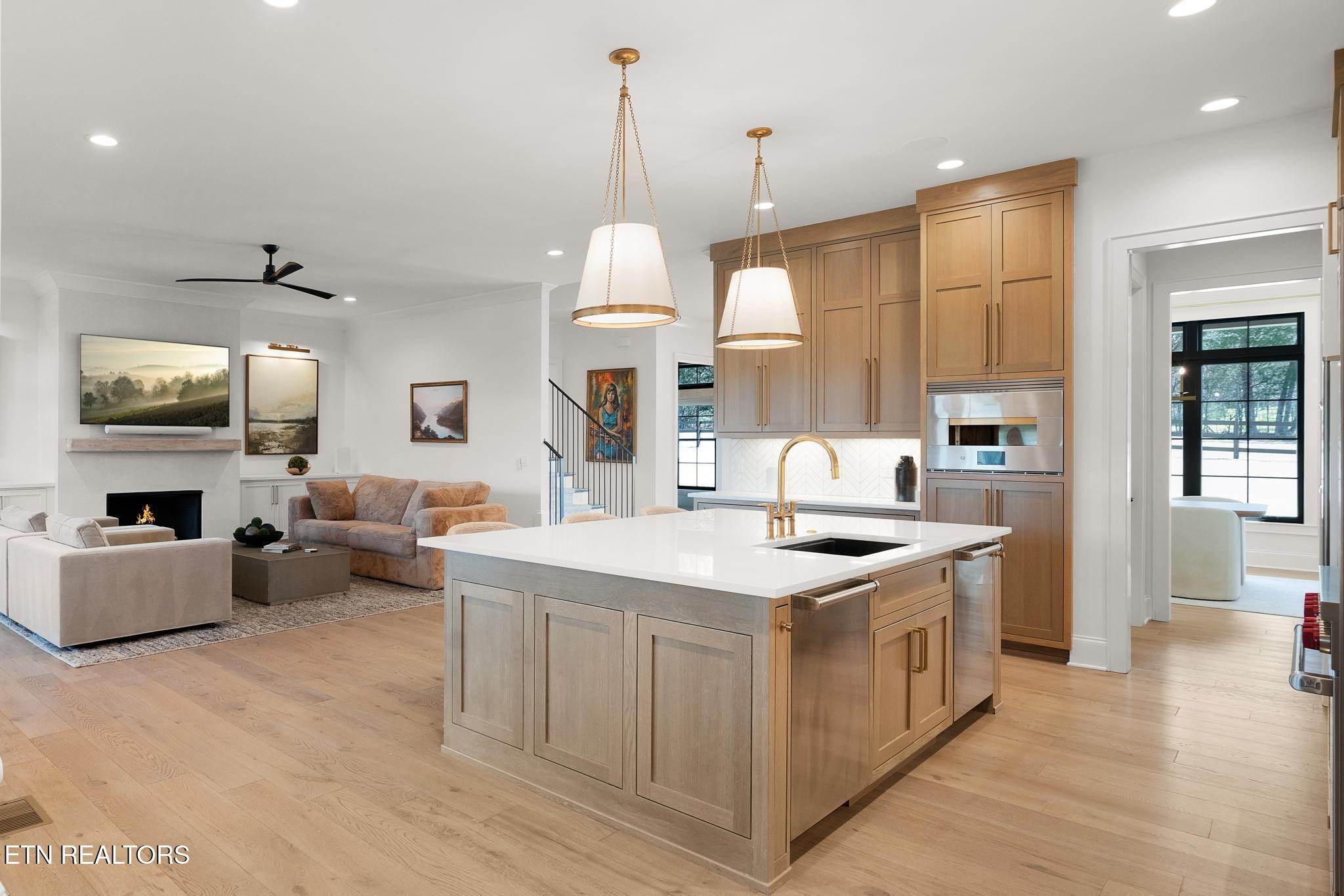 3693 Herschel Hudson Road Lascassas, TN 37085 - Photo 11 of 51 a kitchen with a stove a refrigerator a kitchen island with couches and flat screen tv