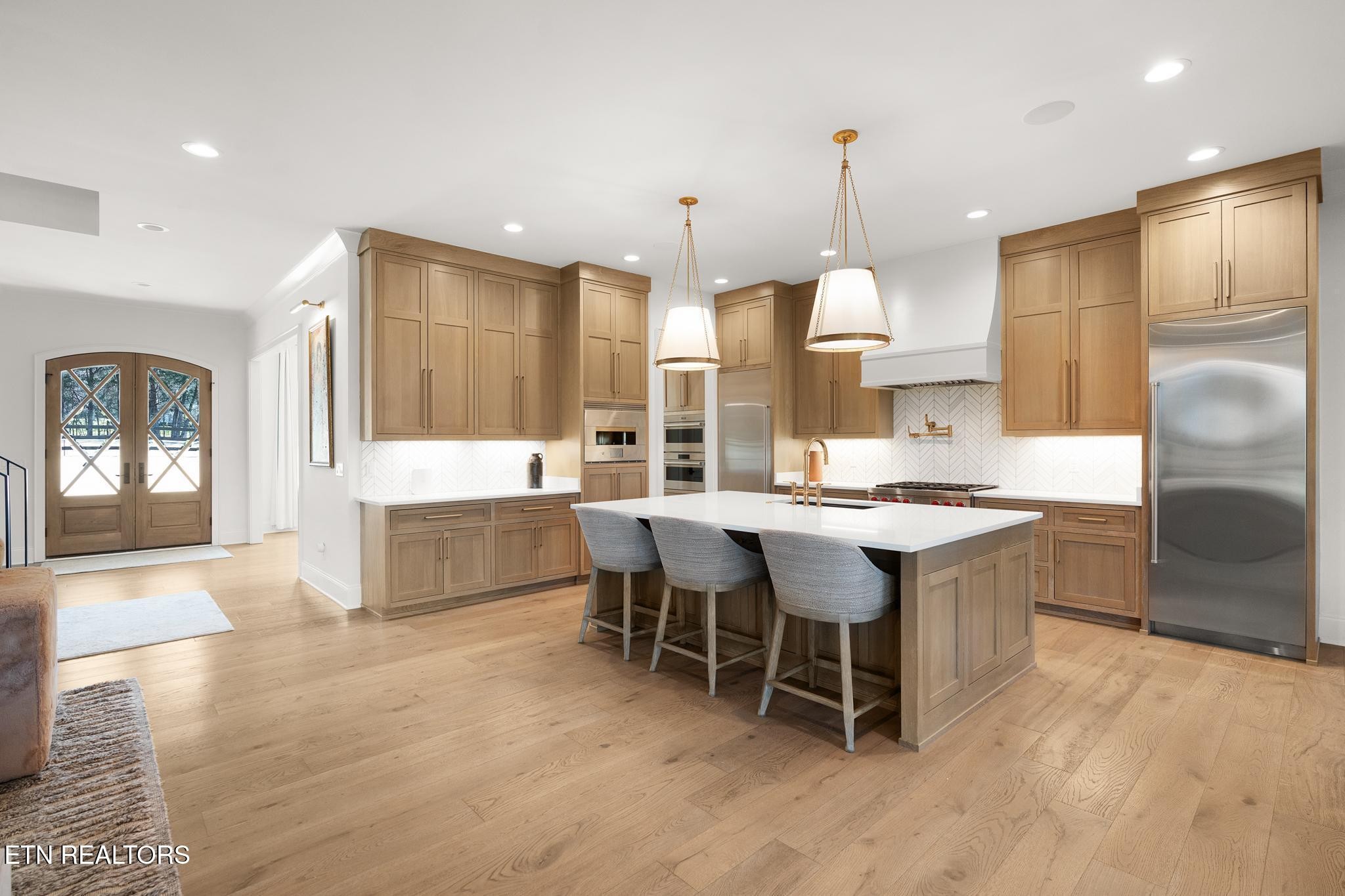 3693 Herschel Hudson Road Lascassas, TN 37085 - Photo 12 of 51 a large kitchen with kitchen island a sink table and chairs