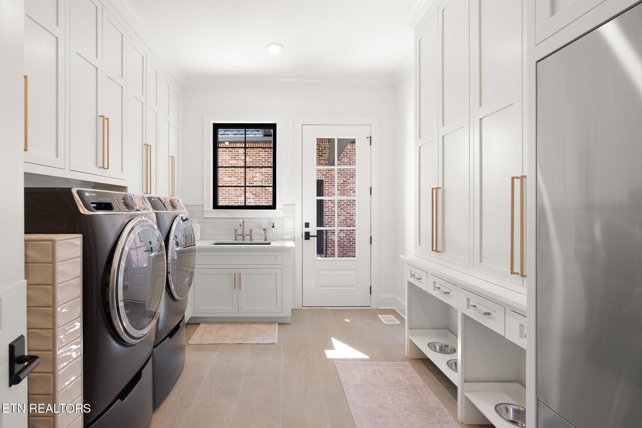 3693 Herschel Hudson Road Lascassas, TN 37085 - Photo 34 of 51 a utility room with multiple dryer and washer