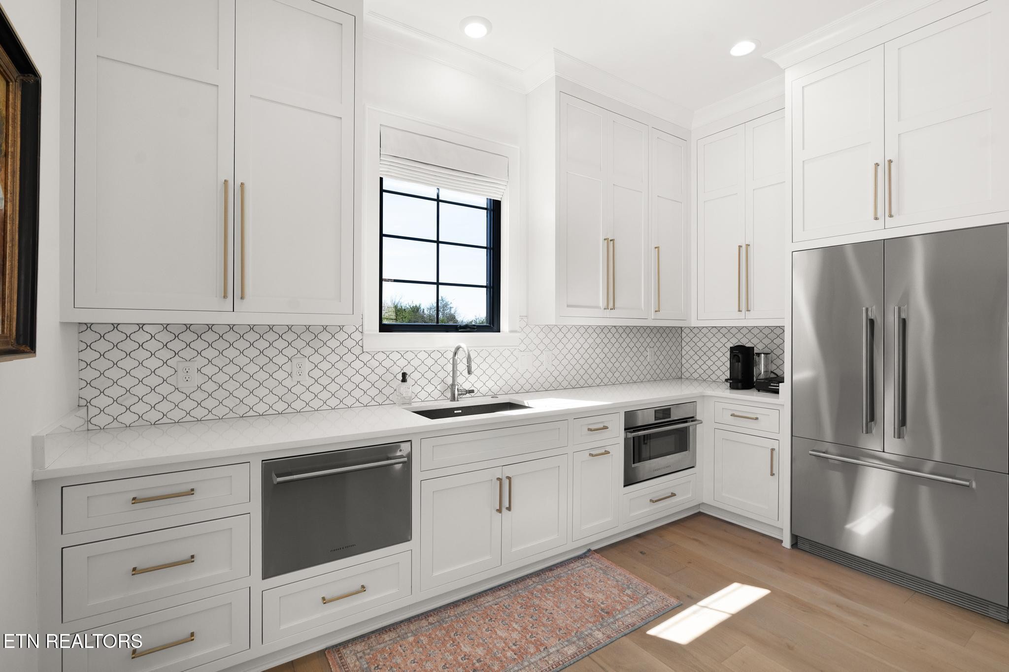 3693 Herschel Hudson Road Lascassas, TN 37085 - Photo 40 of 51 a kitchen with white cabinets stainless steel appliances and sink