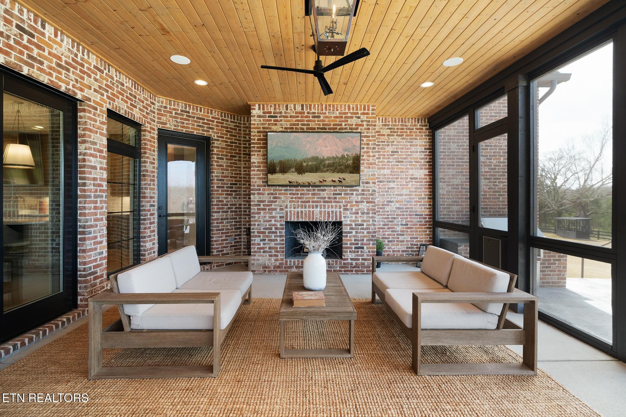 3693 Herschel Hudson Road Lascassas, TN 37085 - Photo 44 of 51 a living room with furniture a flat screen tv and a fireplace