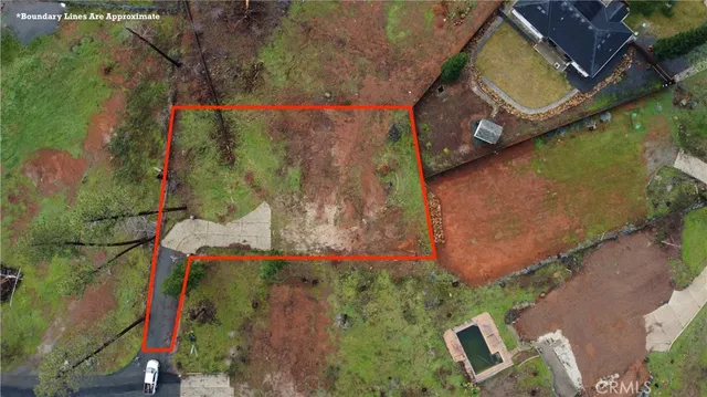 an aerial view of a house with a yard and garden