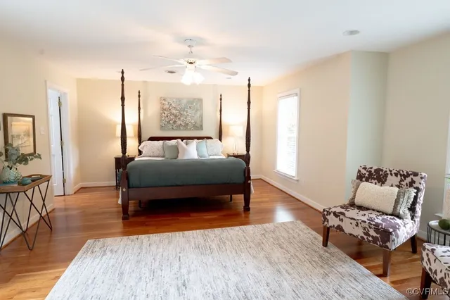 a bedroom with furniture and wooden floor