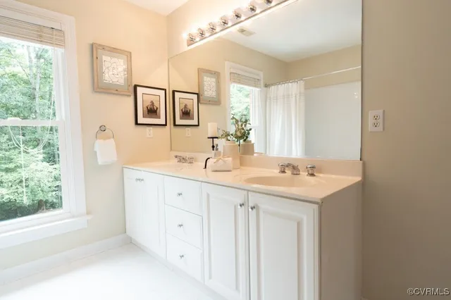 a bathroom with a double vanity sink and a mirror