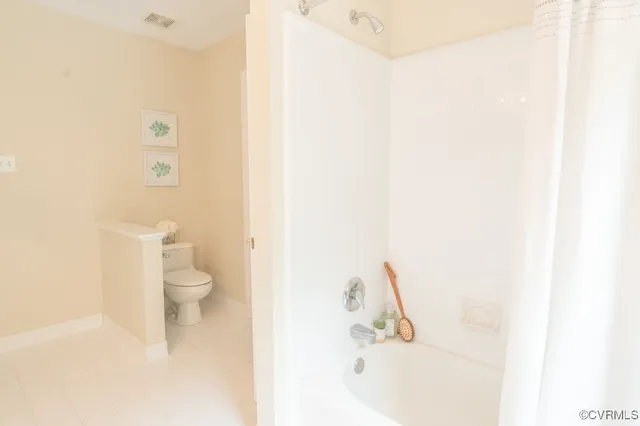 a bathroom with a bathtub and a toilet