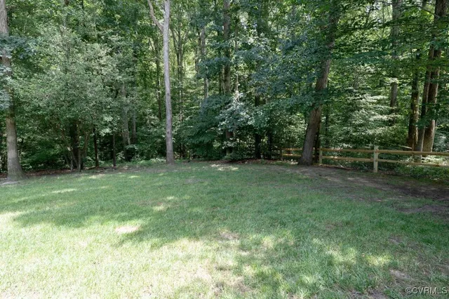 a view of outdoor space with green field and trees