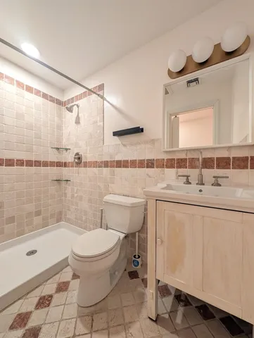 a bathroom with a sink toilet and shower