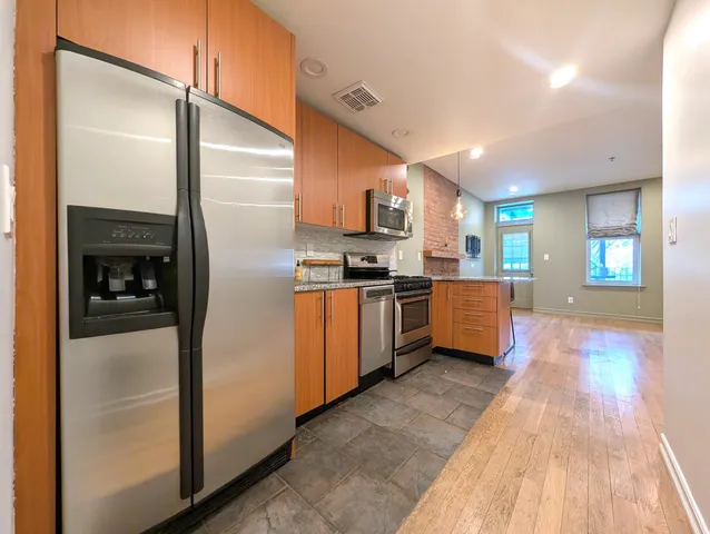 a kitchen with stainless steel appliances a refrigerator and a stove