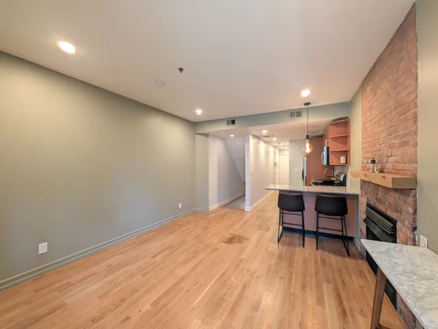 a view of kitchen with sink and refrigerator
