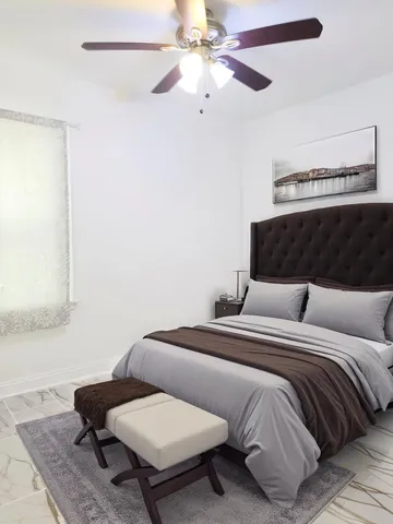 a view of a room that has a fan and a window