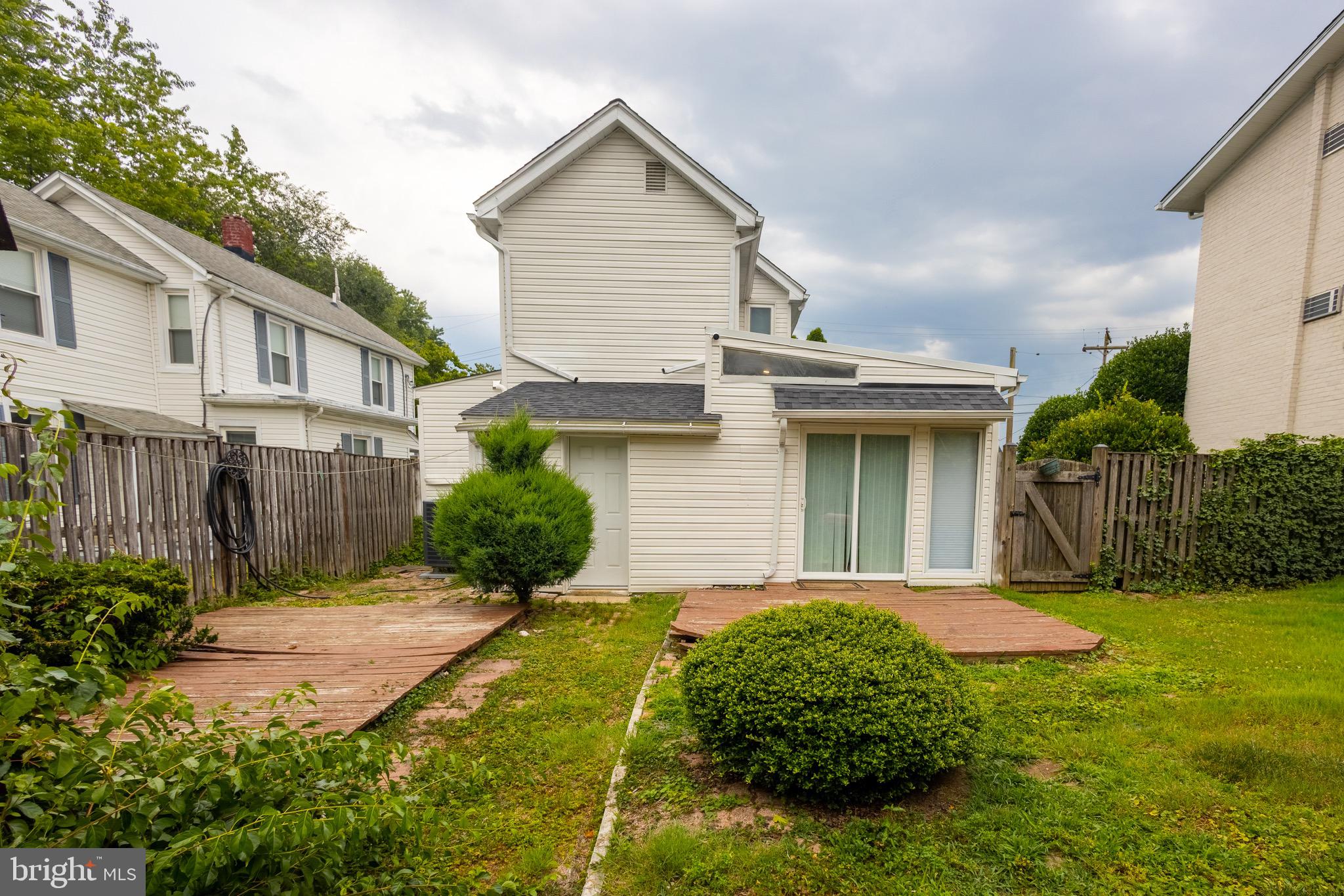 37 4th Street Laurel, MD 20707 - Photo 19 of 26 a front view of a house with a yard and potted plants