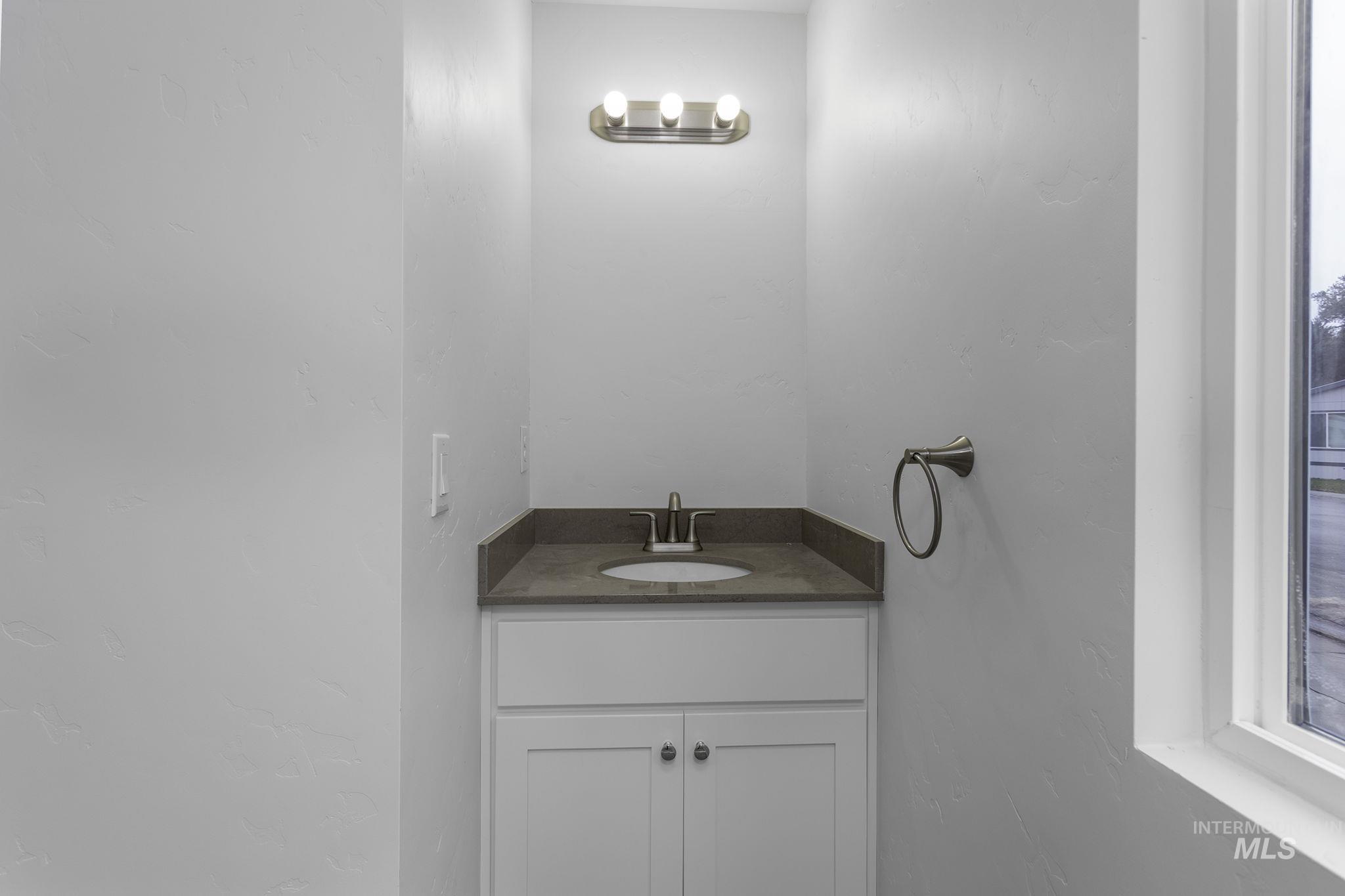 450 Greenleaf Street Boise, ID 83713 - Photo 9 of 17 Bathroom with vanity and a textured wall
